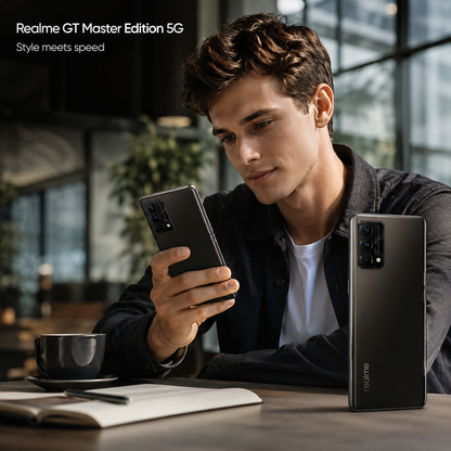 Realme GT Master Edition 5G Cosmos Black smartphone held in hand, rear camera cluster and display visible
