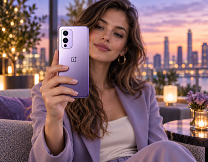 OnePlus 9 5G smartphone in Winter Mist Purple held up by a woman.