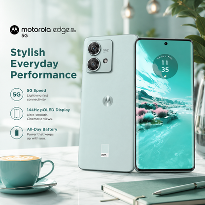 Mint green Motorola smartphone standing with dual rear cameras; front screen shows landscape