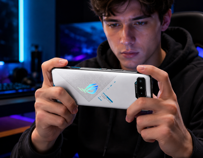 White ASUS ROG phone held in hands, rear camera side visible
