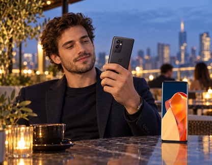 OnePlus 9 Pro smartphone in Stellar Black, held in hand with front display visible