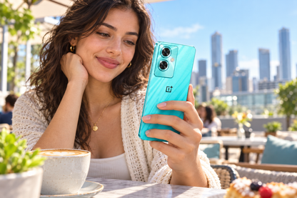 OnePlus Nord N30 SE cyan sparkle smartphone held in hand, showing rear cameras and blue screen