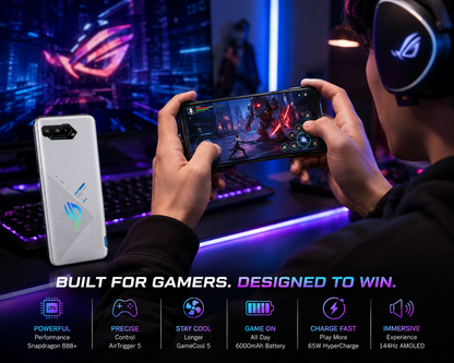 White ASUS ROG Phone 5s 5G held in hands, phone back and gaming screen visible